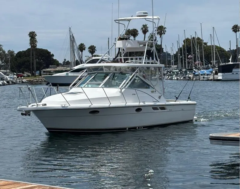 Slide: The Image of 2006 Tiara Yachts 2900 boat docked in a marina under a clear blue sky. - 5