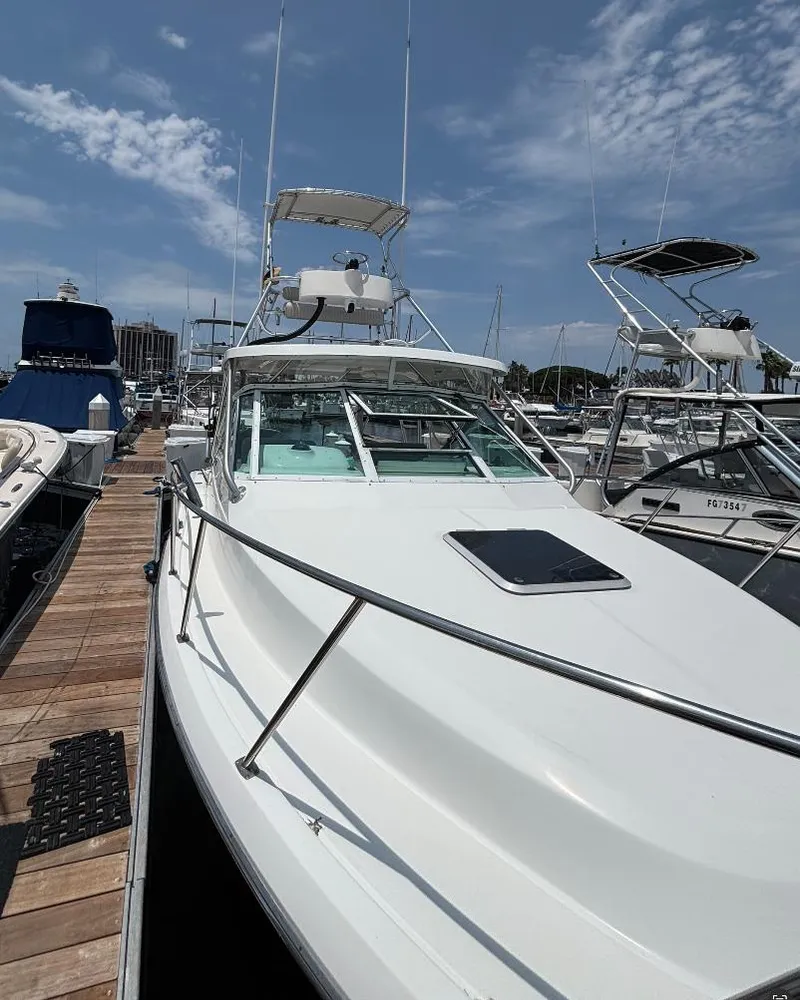 Slide: The Image of 2006 Tiara Yachts 2900 boat with tower, docked in a marina under clear skies. - 7