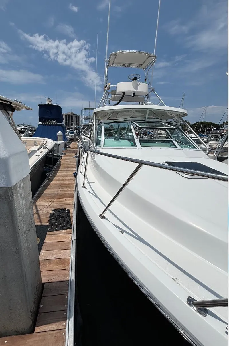 Slide: The Image of 2006 Tiara Yachts 2900 docked at marina under clear blue sky. - 8