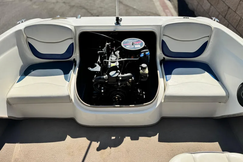 Slide: The Image of 2004 Bayliner 175 Bowrider engine compartment with seating, showcasing interior design. - 14