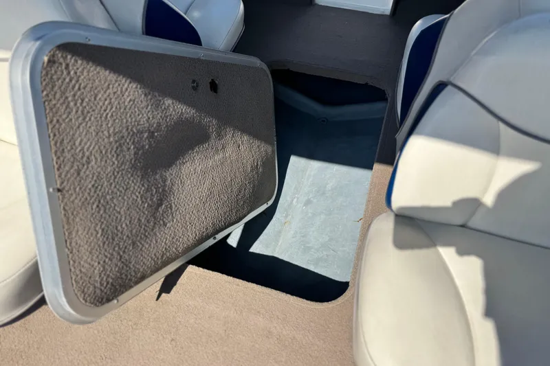Slide: The Image of 2004 Bayliner 175 Bowrider interior storage compartment with open hatch and seating. - 17