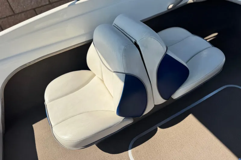 Slide: The Image of 2004 Bayliner 175 Bowrider boat seats, white and blue upholstery, interior view. - 18