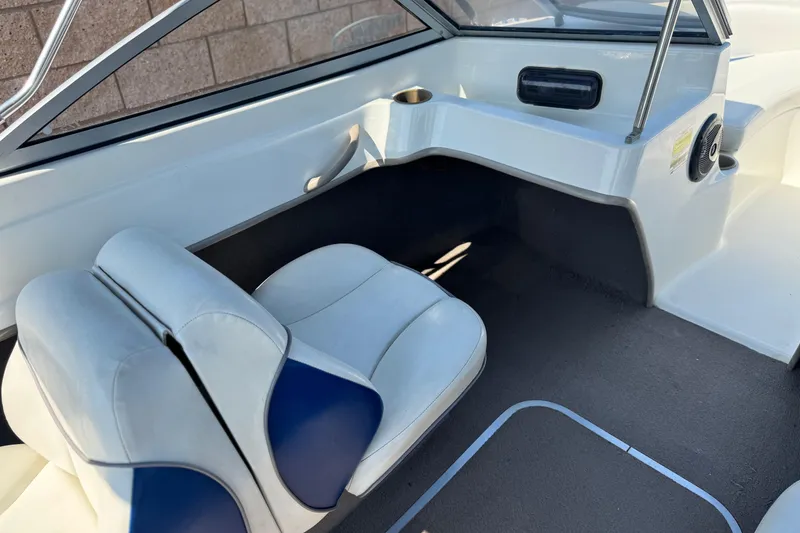 Slide: The Image of 2004 Bayliner 175 Bowrider interior with white and blue seating, showcasing cockpit area. - 19