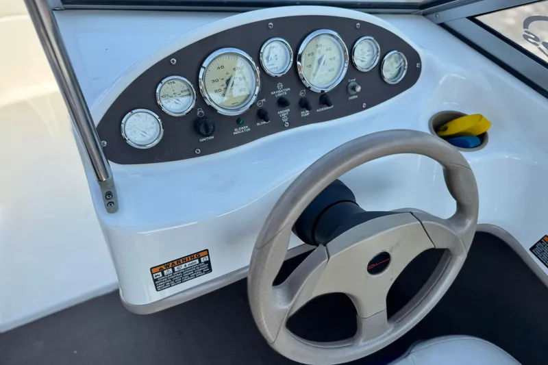 Slide: The Image of Dashboard of a 2004 Bayliner 175 Bowrider boat with steering wheel and gauges. - 24