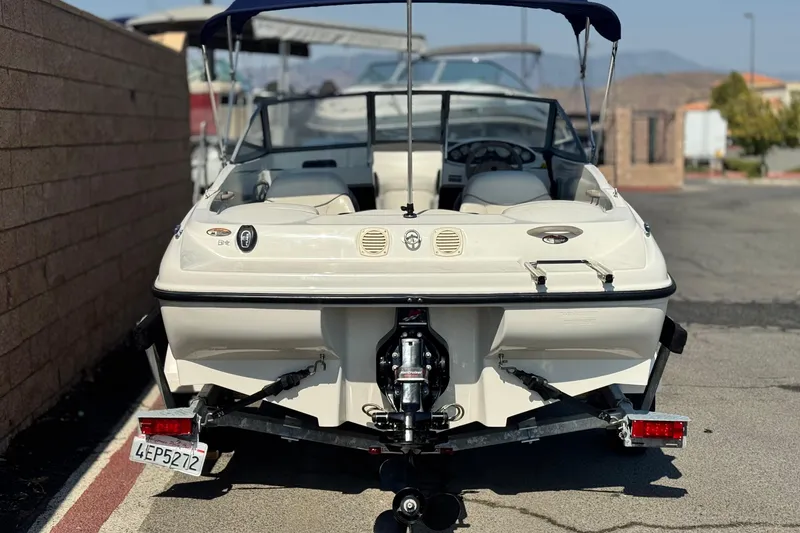 Slide: The Image of 2004 Bayliner 175 Bowrider boat on trailer, rear view, parked outdoors. - 4