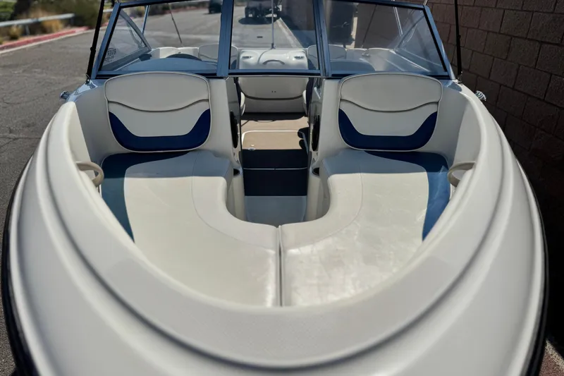 Slide: The Image of 2004 Bayliner 175 Bowrider interior with white and blue seating, windshield view. - 8