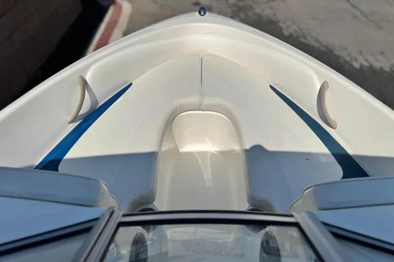 Slide: The Image of 2004 Bayliner 175 Bowrider boat interior with blue accents and seating area. - 9