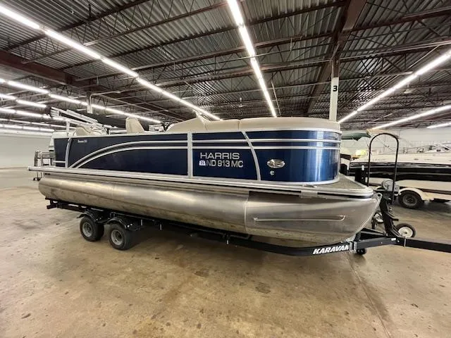 The Image of 2020 Harris Cruiser 210 pontoon boat on trailer in indoor storage facility. - 0