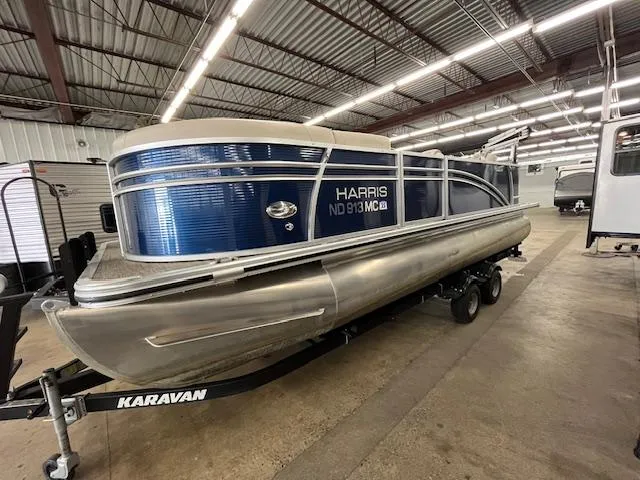 Slide: The Image of 2020 Harris Cruiser 210 pontoon boat on Karavan trailer in indoor storage. - 1