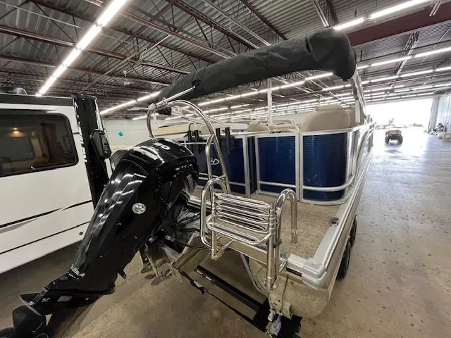 Slide: The Image of 2020 Harris Cruiser 210 pontoon boat with outboard motor in a warehouse setting. - 19