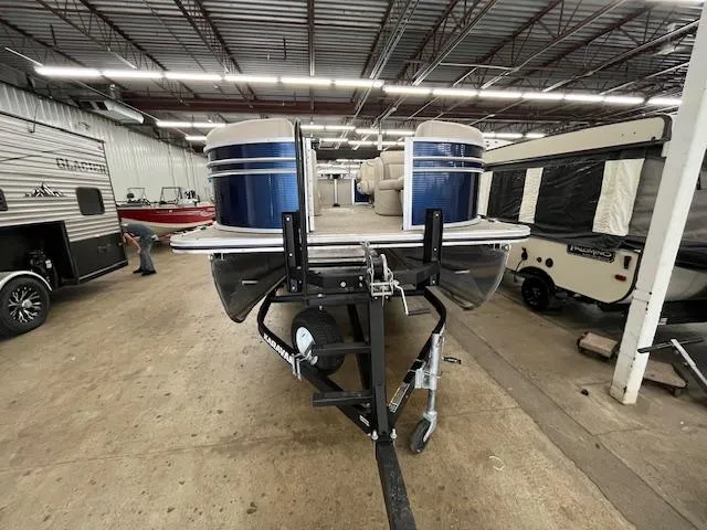Slide: The Image of 2020 Harris Cruiser 210 pontoon boat on trailer in indoor storage facility. - 3