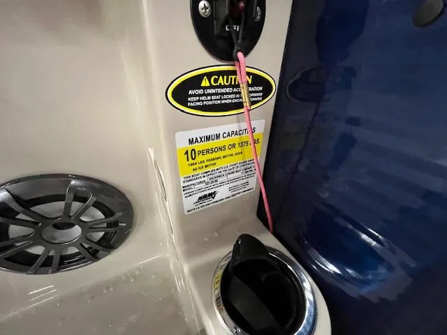 Slide: The Image of 2020 Harris Cruiser 210 boat capacity label, caution sign, and speaker detail. - 4