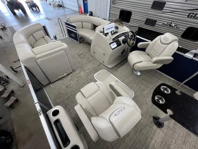 Slide: The Image of 2020 Harris Cruiser 210 pontoon boat interior with beige seating and modern dashboard. - 6