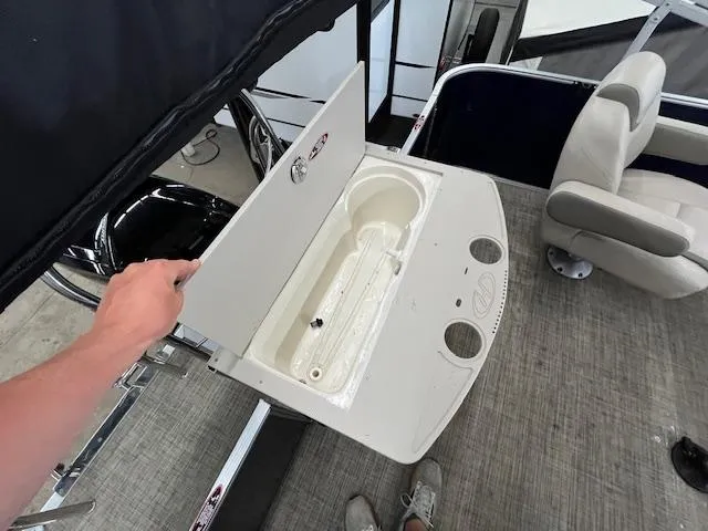 Slide: The Image of 2020 Harris Cruiser 210 boat interior with open storage compartment and seating. - 8