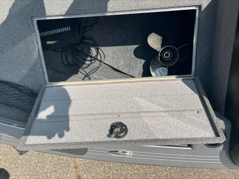 Slide: The Image of 2016 Crestliner Raptor 1850 storage compartment with propeller and Humminbird equipment. - 11