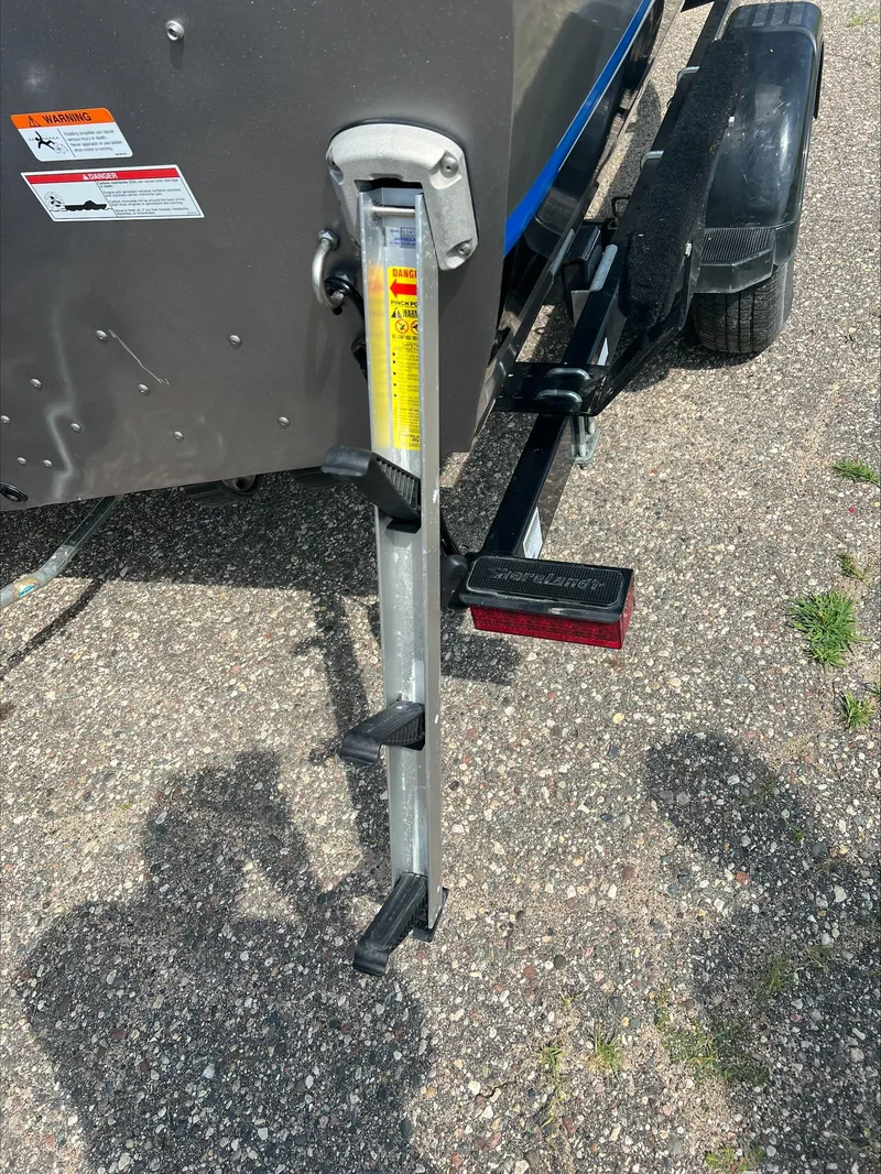 Slide: The Image of Boat trailer ladder attached to a 2016 Crestliner Raptor 1850, parked on gravel. - 15