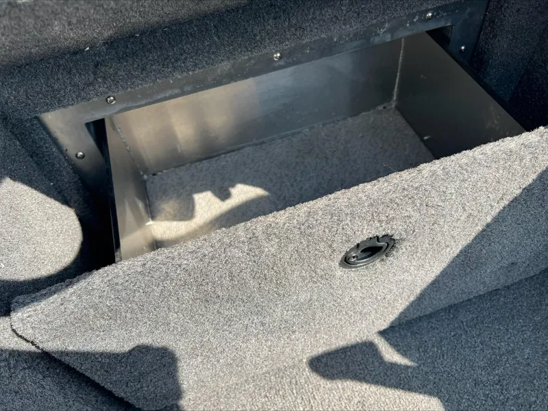 Slide: The Image of Carpeted storage compartment in a 2016 Crestliner Raptor 1850 boat. - 19