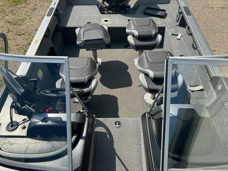 Slide: The Image of 2016 Crestliner Raptor 1850 boat interior with seating and steering console. - 21
