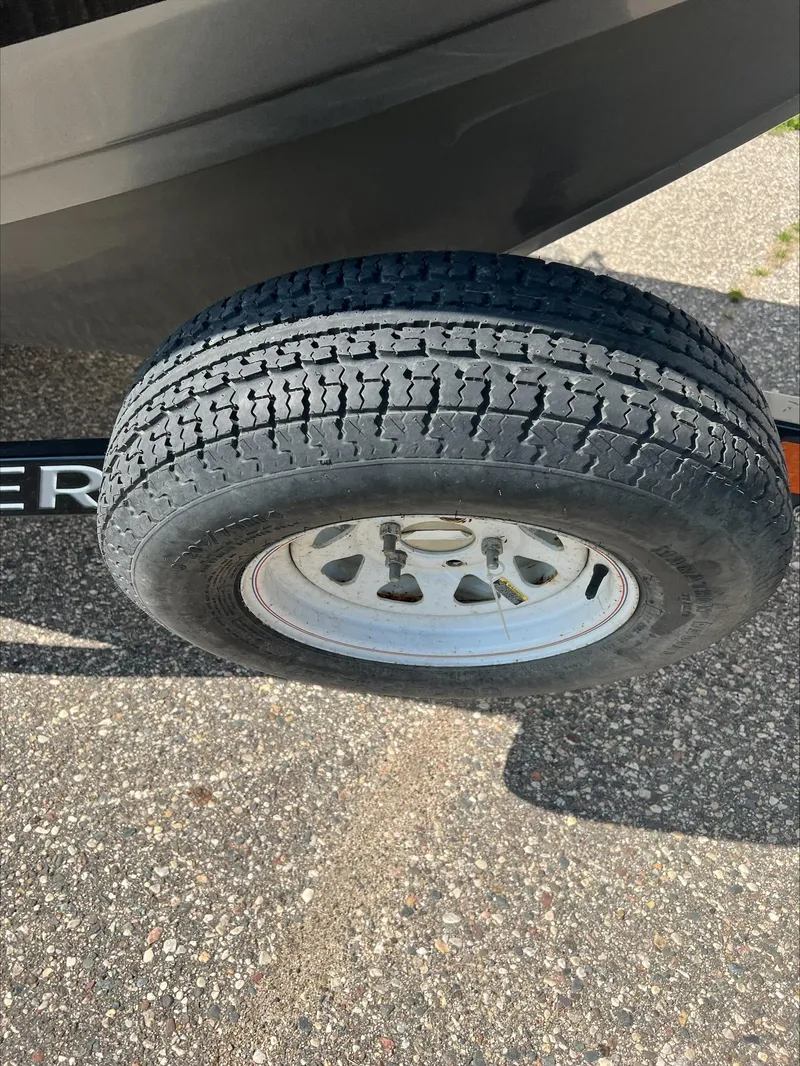 Slide: The Image of Trailer tire of a 2016 Crestliner Raptor 1850 on pavement. - 22