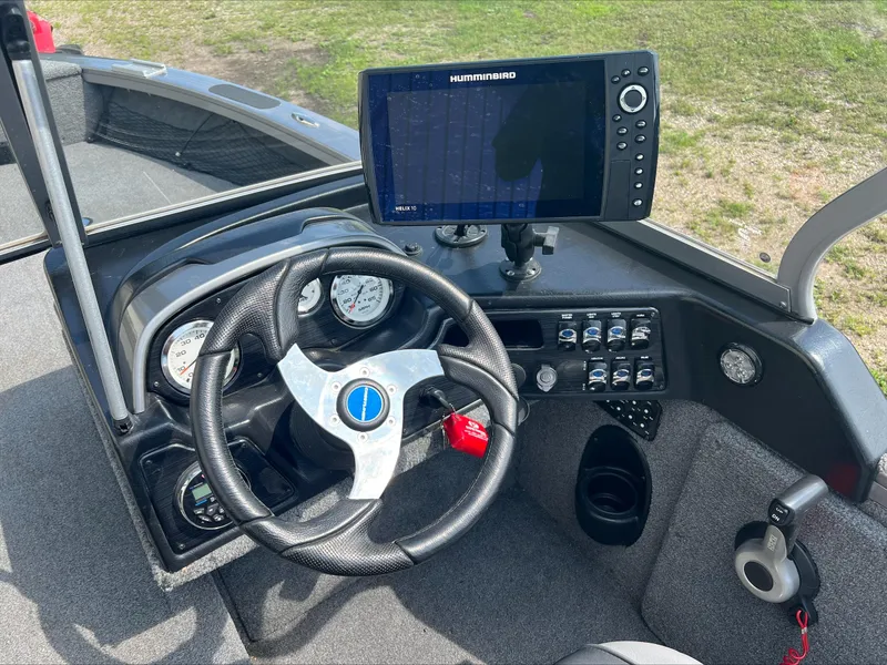Slide: The Image of 2016 Crestliner Raptor 1850 dashboard with steering wheel and Humminbird fish finder. - 23
