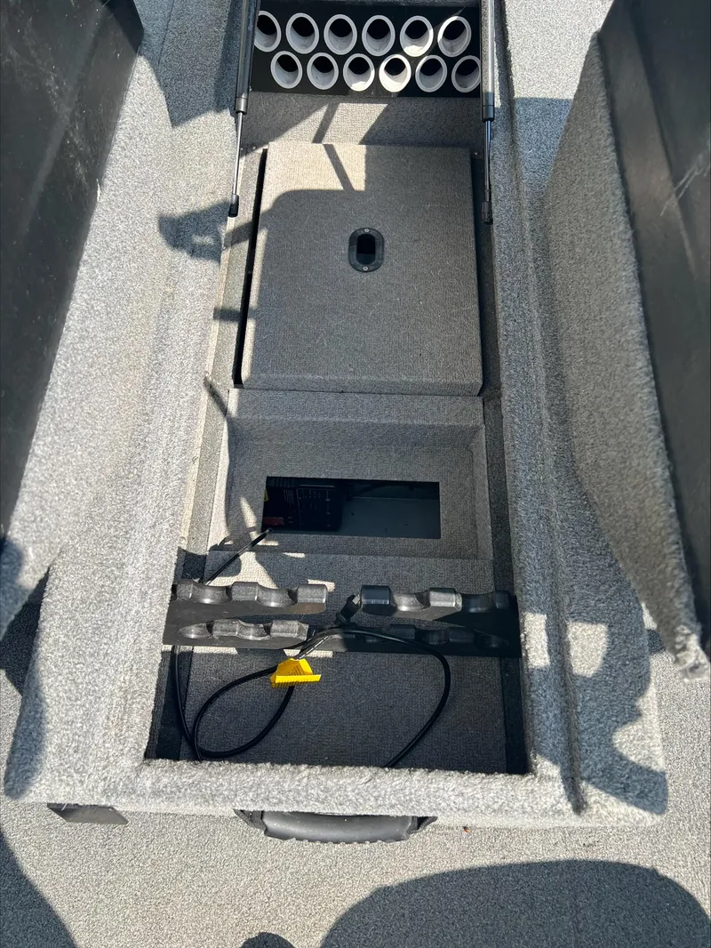 Slide: The Image of 2016 Crestliner Raptor 1850 interior storage compartment with rod holders and wiring. - 4