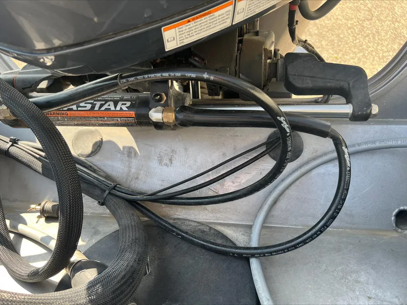 Slide: The Image of Close-up of 2016 Crestliner Raptor 1850 boat engine components and hydraulic steering system. - 8