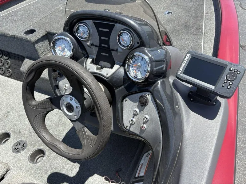 Slide: The Image of 2019 Tracker Pro Team™ 195 TXW boat dashboard with steering wheel and Lowrance fishfinder. - 13