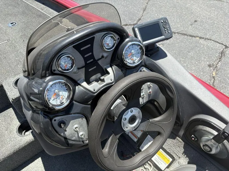 Slide: The Image of 2019 Tracker Pro Team™ 195 TXW boat dashboard with gauges and steering wheel. - 16