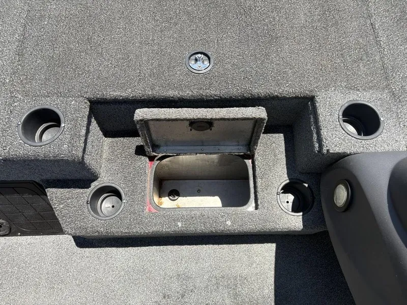 Slide: The Image of 2019 Tracker Pro Team™ 195 TXW boat interior with storage compartment and cup holders. - 17