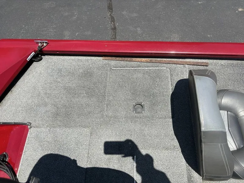 Slide: The Image of 2019 Tracker Pro Team™ 195 TXW boat interior with gray carpet and seating. - 19