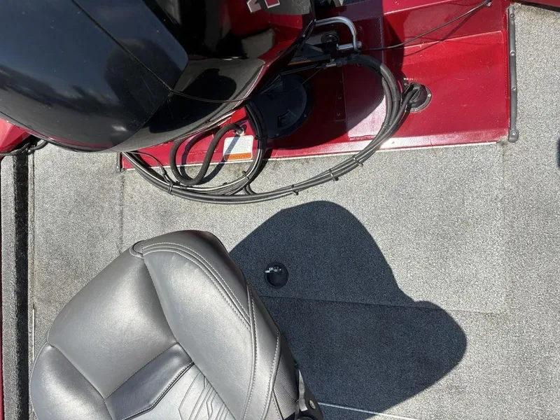 Slide: The Image of 2019 Tracker Pro Team™ 195 TXW boat interior with gray seat and red flooring. - 20