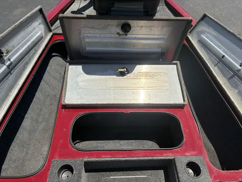 Slide: The Image of 2019 Tracker Pro Team™ 195 TXW boat storage compartments open, showing interior layout. - 7
