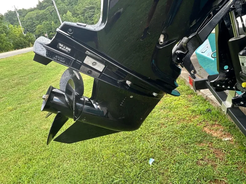 Slide: The Image of Close-up of 2023 Bayliner Element M17 boat motor and propeller on grass. - 8