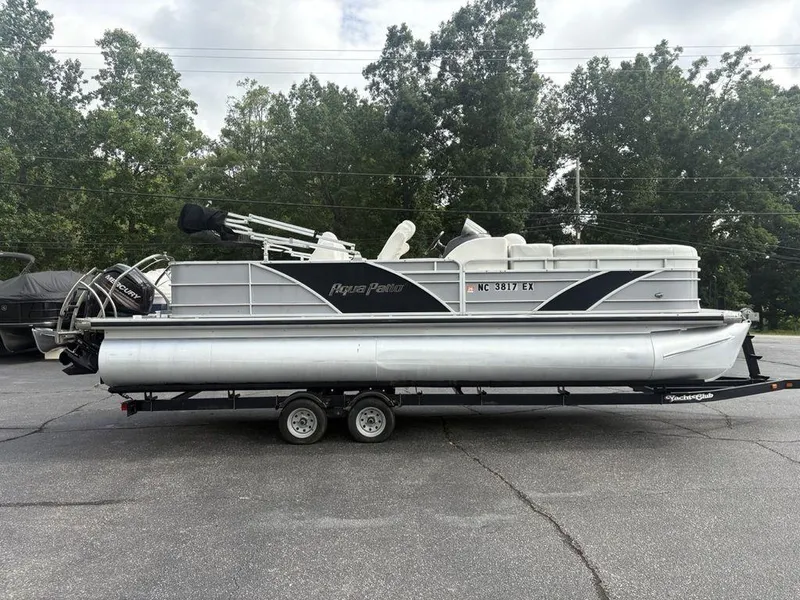 The Image of 2013 Godfrey AP250 RL pontoon boat on trailer, parked outdoors. - 1