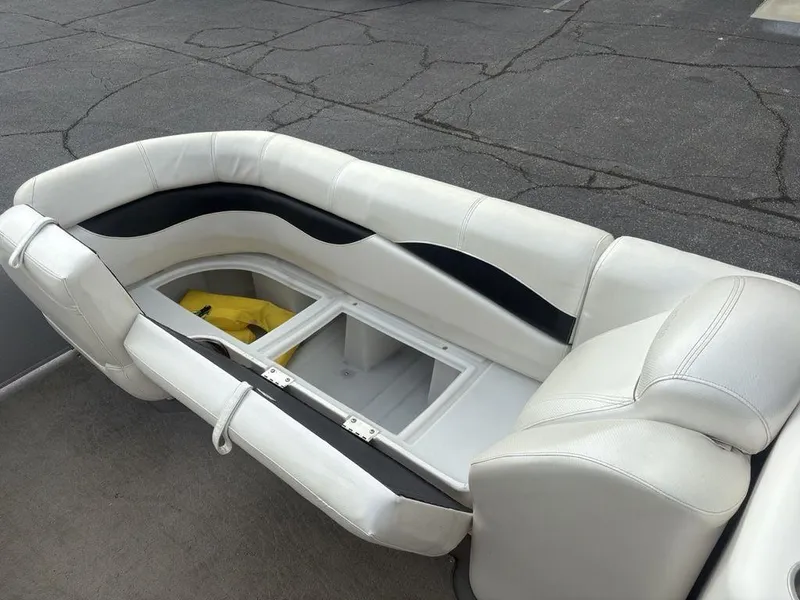 Slide: The Image of White leather seating with storage compartment on a 2013 Godfrey AP250 RL boat. - 11