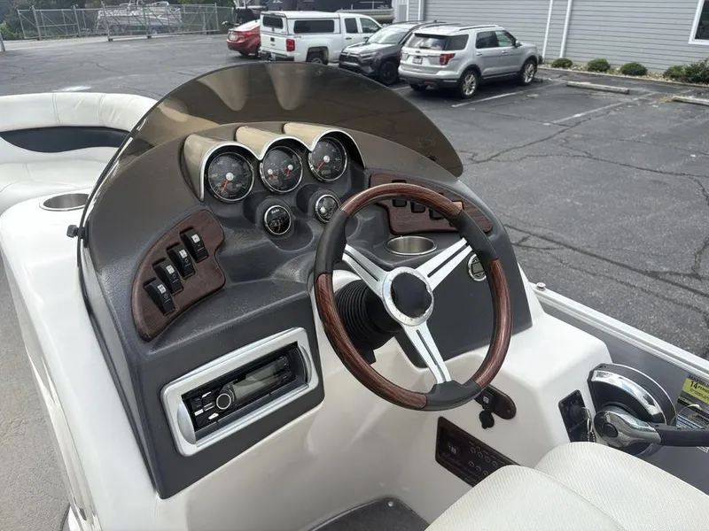 Slide: The Image of Steering console of a 2013 Godfrey AP250 RL boat with gauges and controls. - 14
