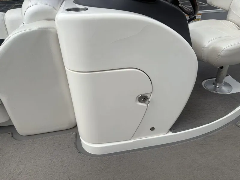 Slide: The Image of White console and seating on a 2013 Godfrey AP250 RL boat. - 15