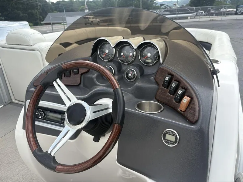 Slide: The Image of Steering console of 2013 Godfrey AP250 RL boat with gauges and controls. - 17