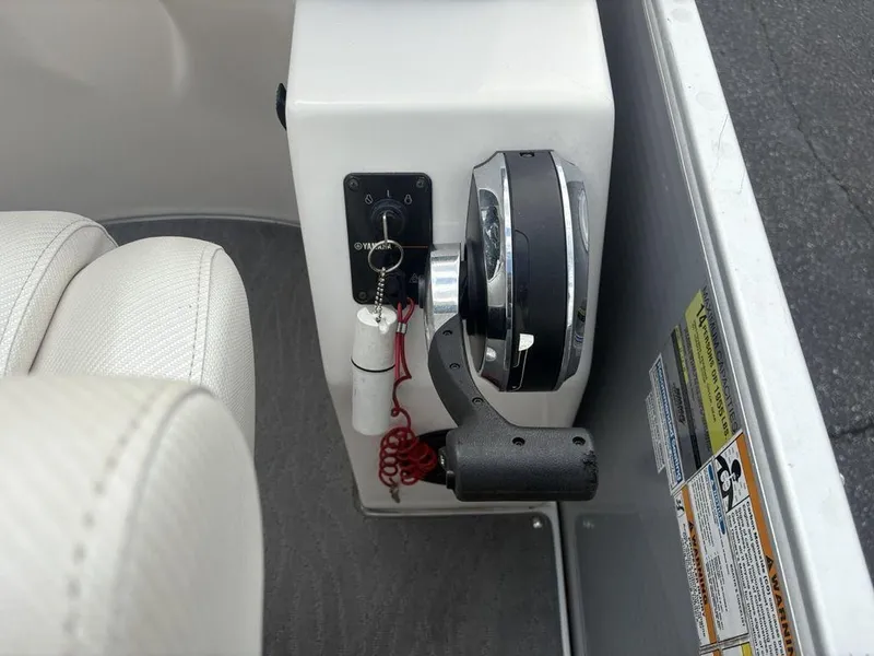 Slide: The Image of Control panel of a 2013 Godfrey AP250 RL boat with throttle and ignition. - 19