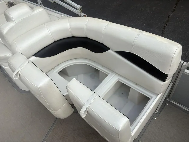 Slide: The Image of White and black seating with storage on a 2013 Godfrey AP250 RL boat. - 22
