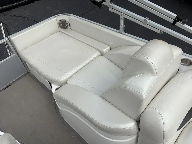 Slide: The Image of 2013 Godfrey AP250 RL boat with white leather seating and speaker. - 25