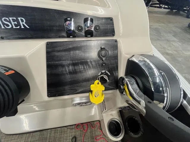 Slide: The Image of Control panel of a 2017 Harris Cruiser 200 boat with steering wheel and ignition. - 12