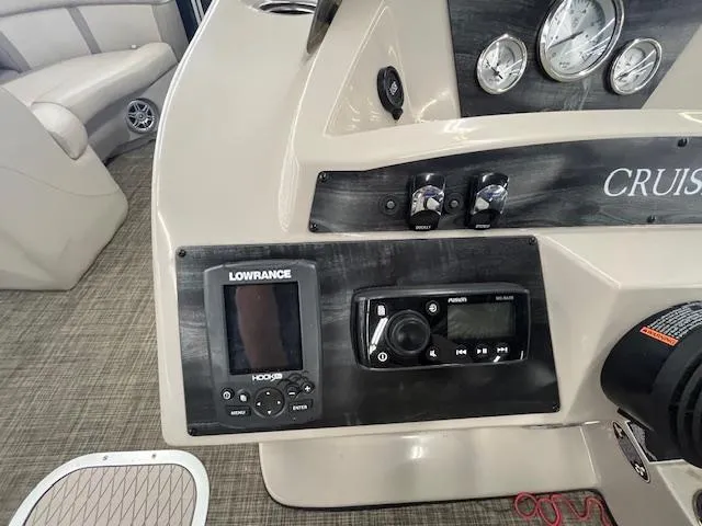 Slide: The Image of Control panel of a 2017 Harris Cruiser 200 boat with navigation and audio systems. - 13