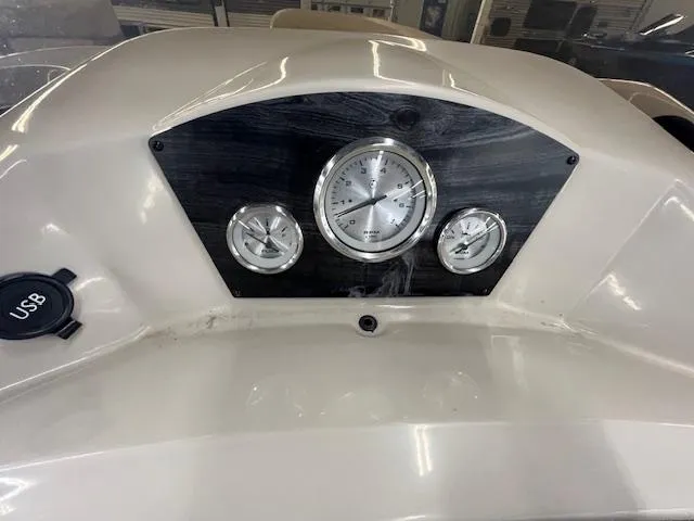 Slide: The Image of Dashboard of 2017 Harris Cruiser 200 boat with gauges and USB port. - 14