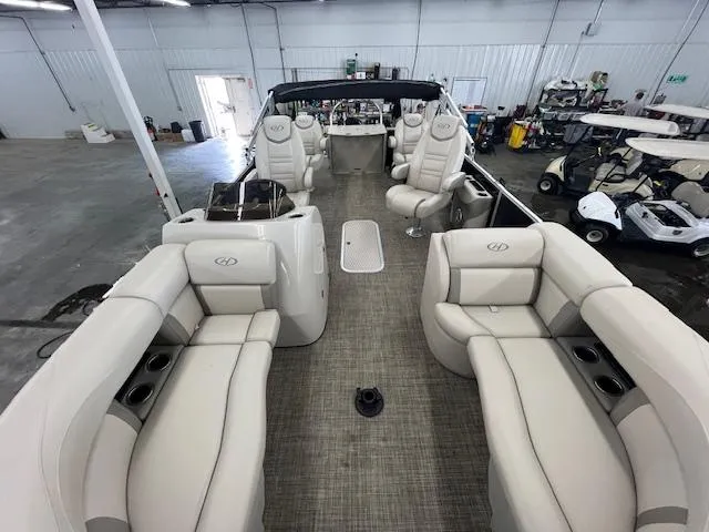 Slide: The Image of Interior of 2017 Harris Cruiser 200 pontoon boat with beige seating in a warehouse. - 17