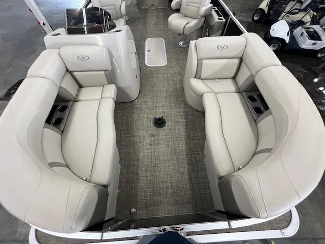 Slide: The Image of 2017 Harris Cruiser 200 pontoon boat interior with beige seating and cup holders. - 18