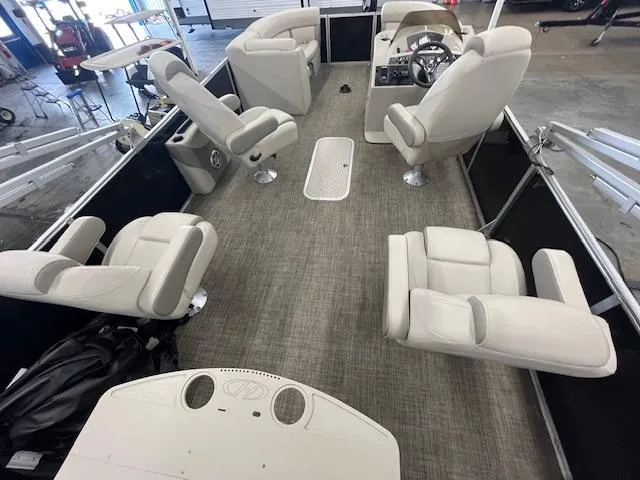 Slide: The Image of 2017 Harris Cruiser 200 pontoon boat interior with beige seating and steering console. - 6