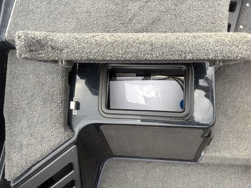 Slide: The Image of 2023 Skeeter ZXR 20 boat storage compartment with carpeted interior. - 11