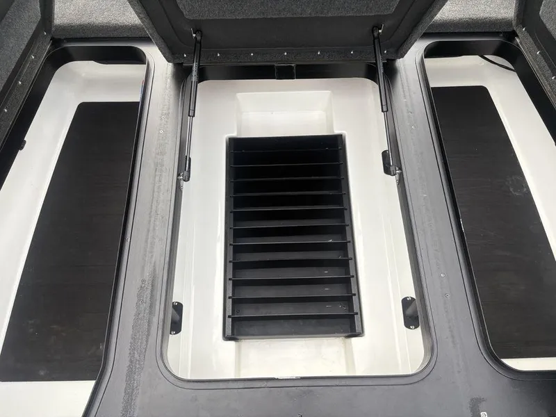 Slide: The Image of 2023 Skeeter ZXR 20 boat storage compartments with open lids and organized interior. - 13
