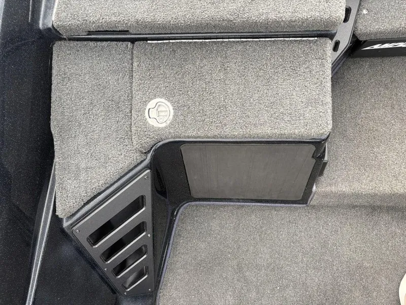 Slide: The Image of 2023 Skeeter ZXR 20 boat interior with carpeted storage compartment and latch. - 15